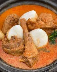 Rice ball with groundnut soup, cowmeat,fish,and wele