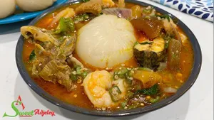 Banku with okro stew with wele, beef, cowmeat and fish